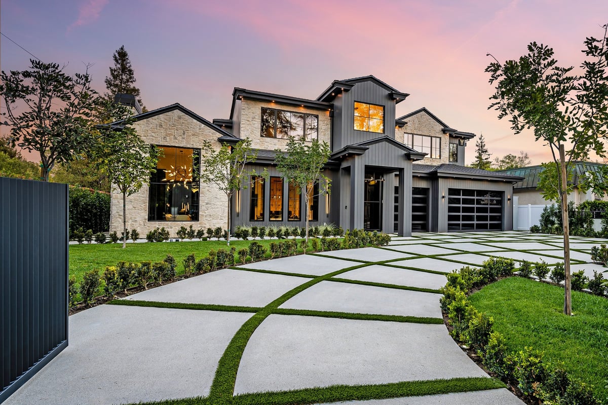 Modern luxury home exterior with well-manicured lawn