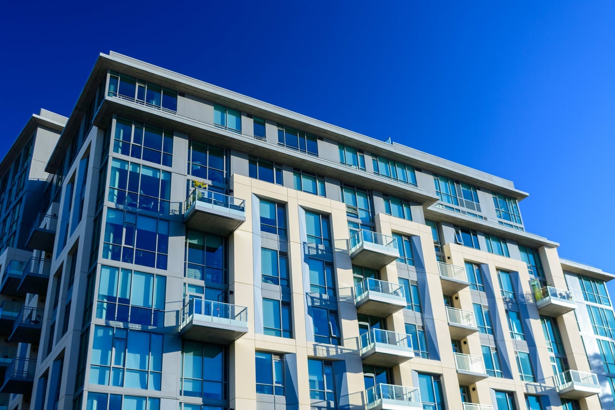 Modern high-rise apartment building with glass windows and balconies