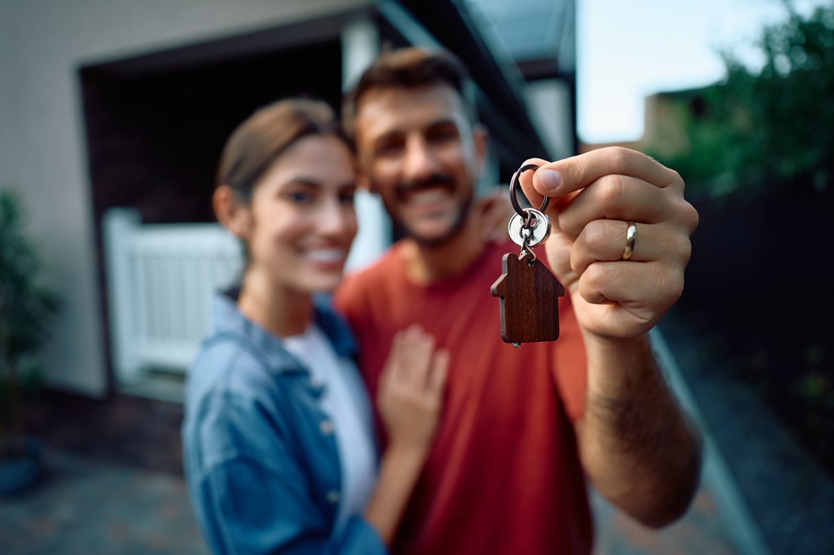 Close up of couple with new house keys.