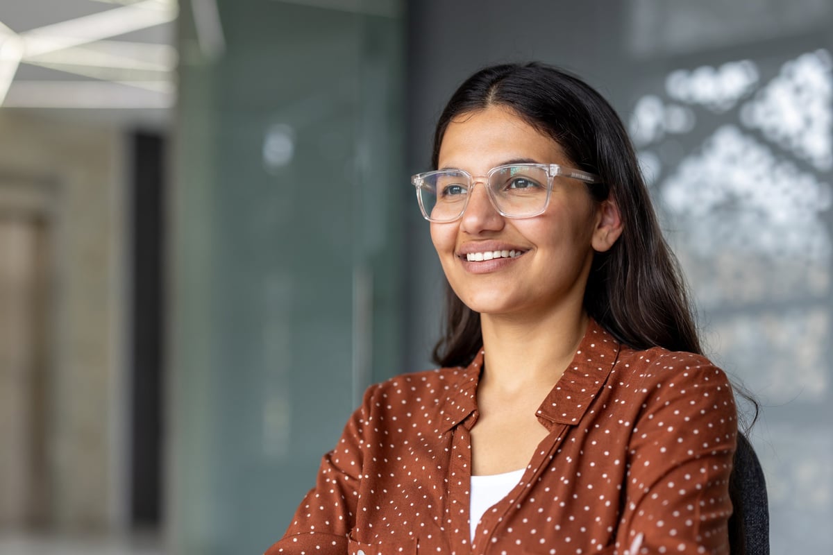Young professional woman smiling confidently in modern office